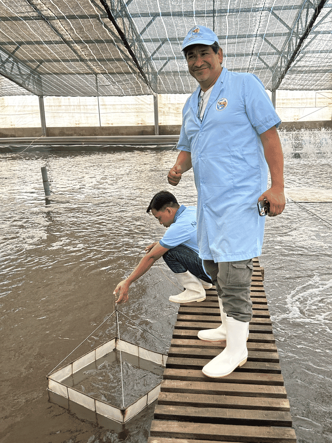 Two men at a shrimp farm.