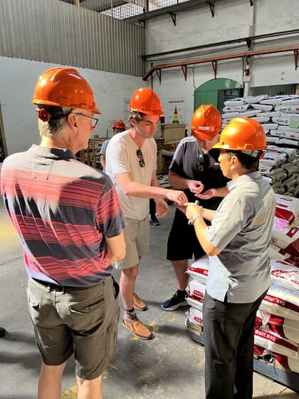 Four men in hard hats talking