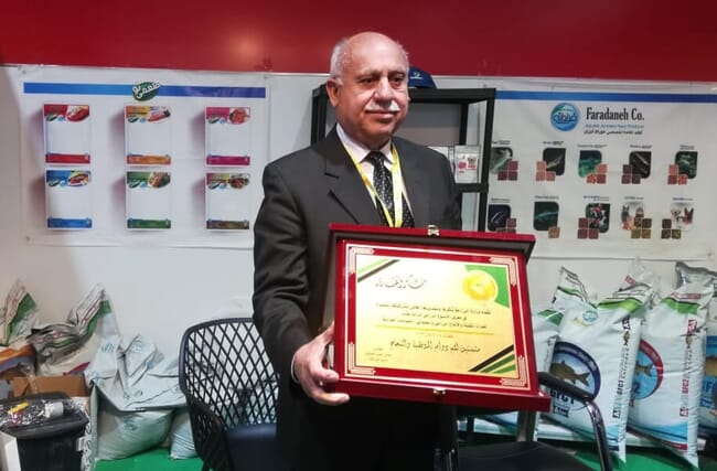 A man holding a golden certificate.