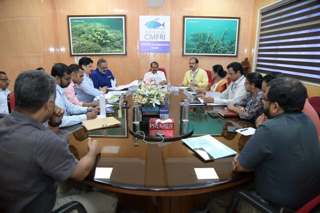 A group of people sitting around a meeting table.