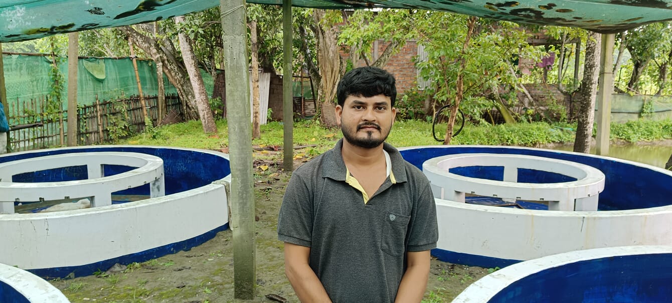 Nitul Chandra Das, a fish farmer in Assam, next to his ponds.