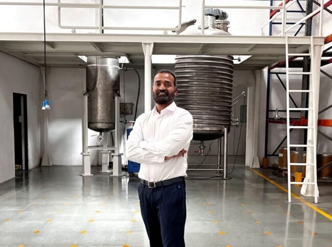 A man standing in a warehouse.