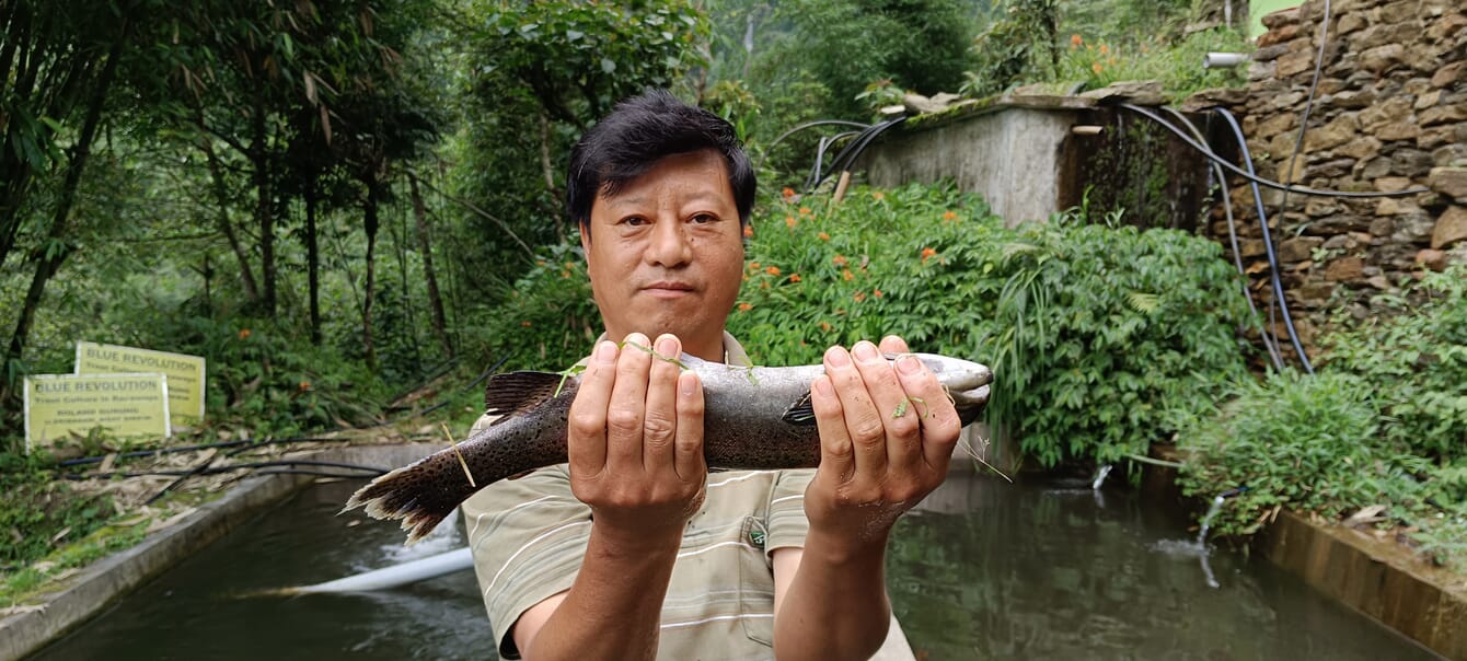 un hombre con un pez en la mano