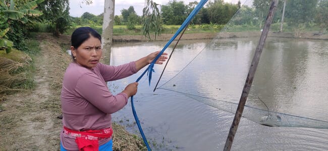 a woman pulling in a net