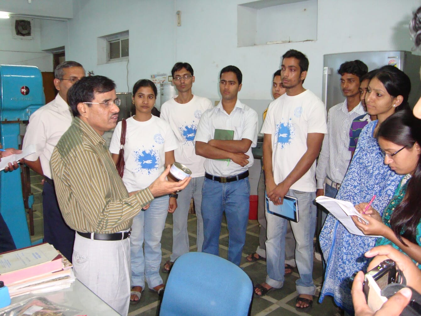 An expert shrimp farmer training aquaculture students in India.