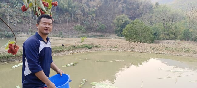 a man holding a blue bucket