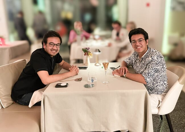 Two people sitting at a table in a smart restaurant