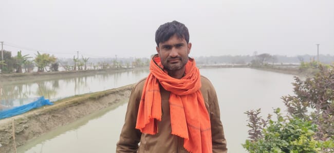 Man standing near flooded fields