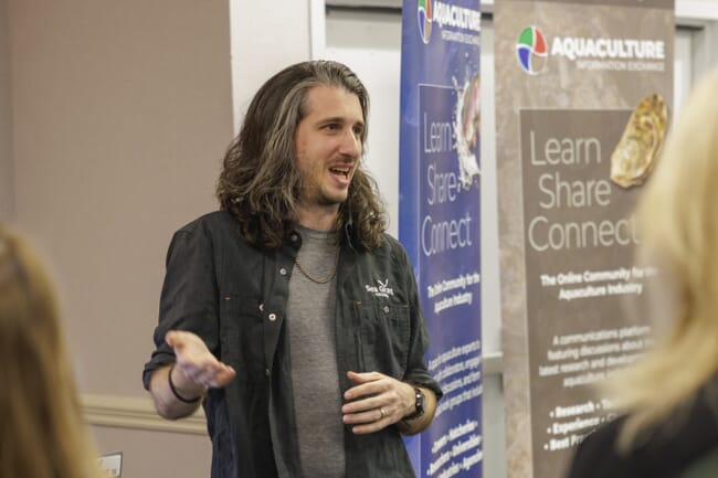A long-haired man giving a presentation.