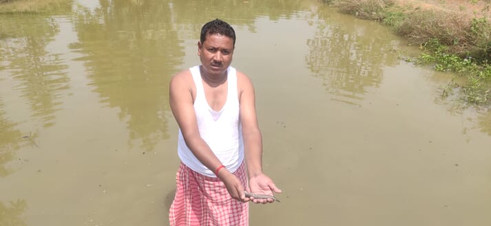 Man holding a small fish