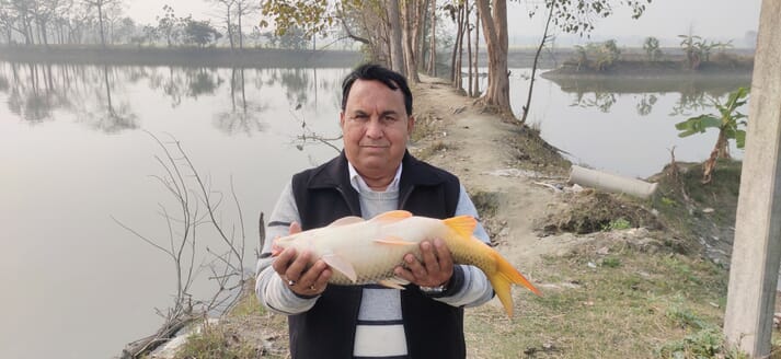man holding a yellow fish