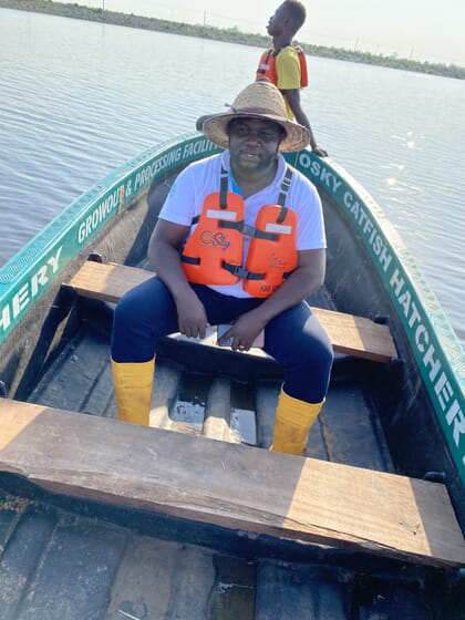 Homem sentado em um pequeno barco de madeira