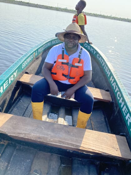 Man sitting on a small wooden boat