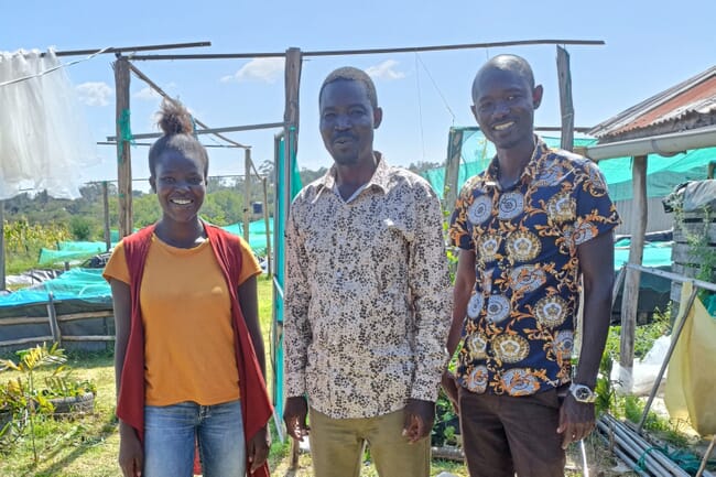 Three people on a fish farm