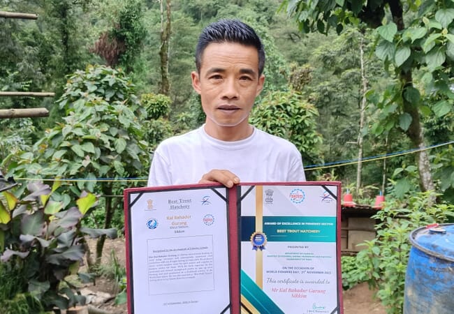 Man holding awards certificates