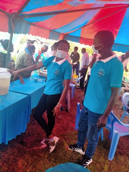 two people standing at a market stall