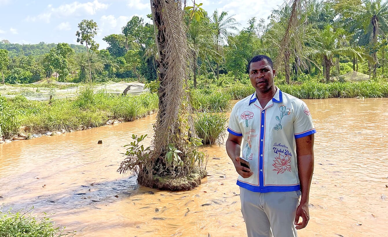 Fish farmer standing in front of a catfish pond