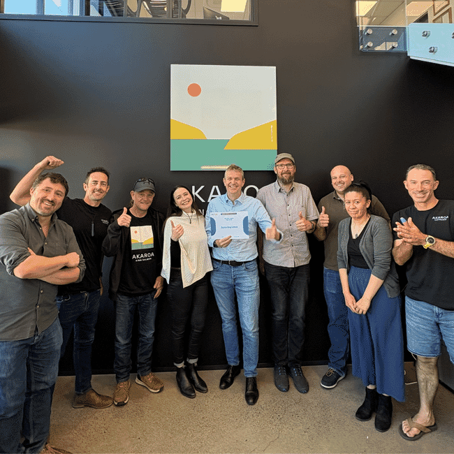 A group of salmon farmers from New Zealand holding a sustainability award.
