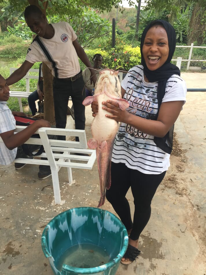 Funke Olatunde with a gravid female catfish