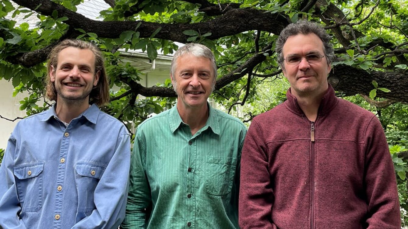 three men posing for a photo