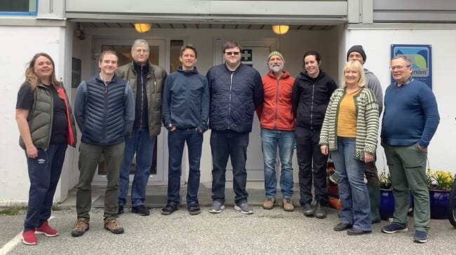 A group photo outside a lab.