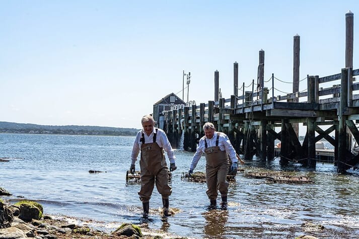 two people stepping out of water