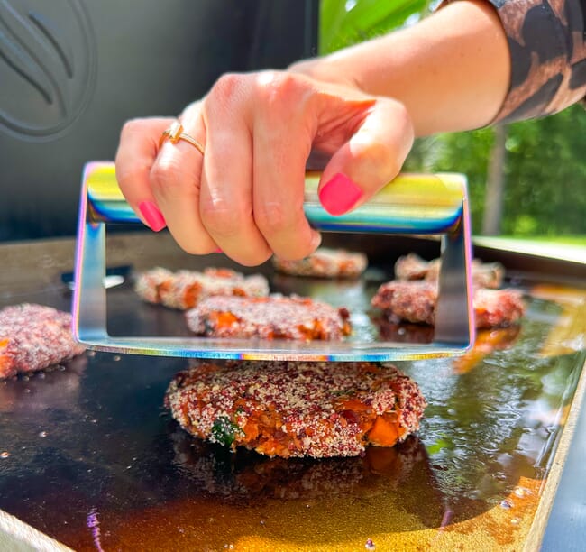 A fish and vegetable smash burger cooking in the USA.