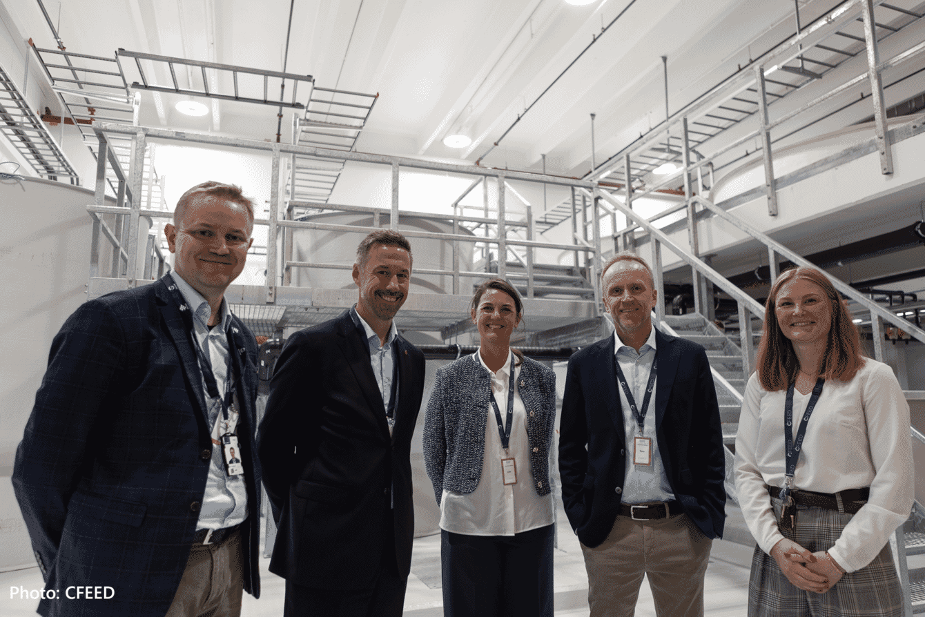 A group of people celebrating the launch of an expended aquaculture live feed production factory.