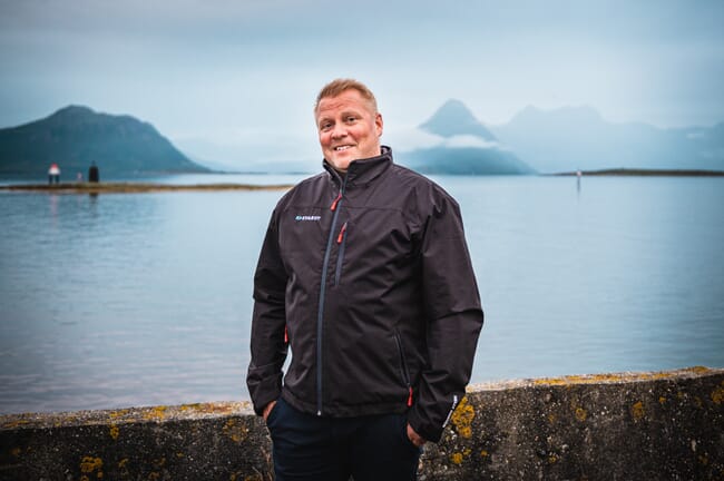 man stands in front of fjord