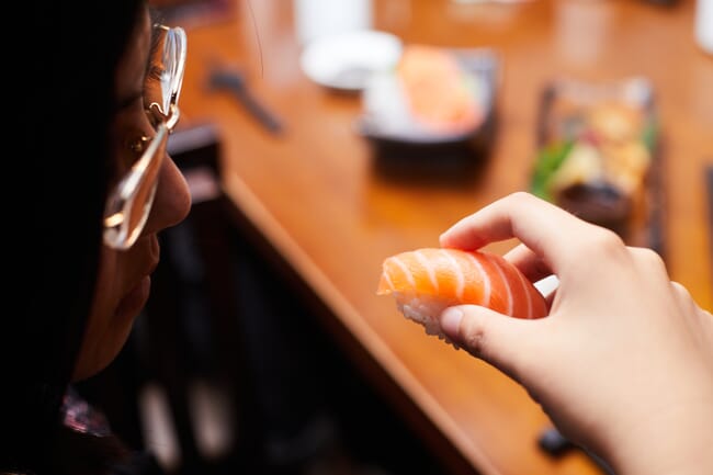 A person about to eat some sushi.