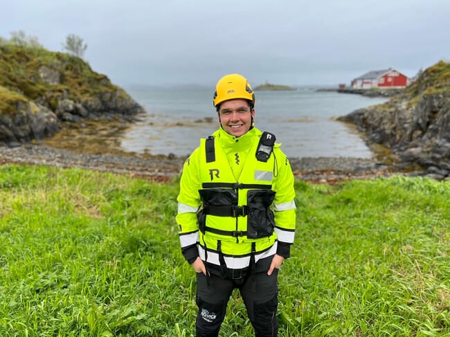 Headshot of young man wearing a helmet and hi viz jacket