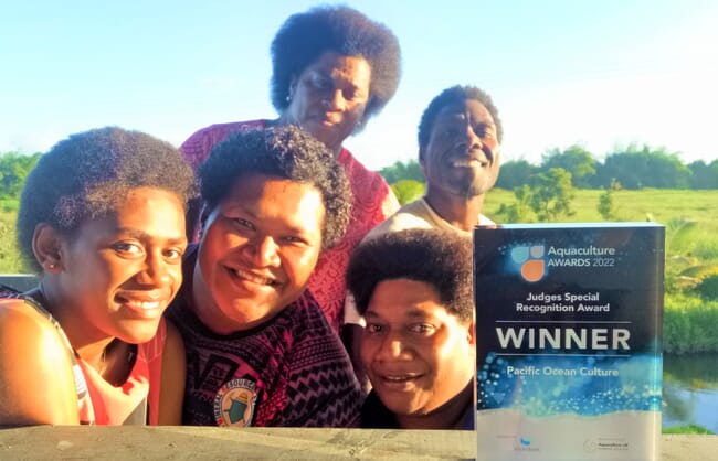 Group posing with an award