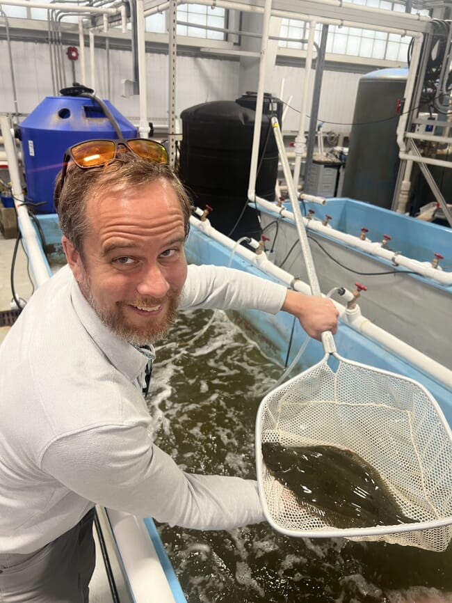 A man holding a flatfish.