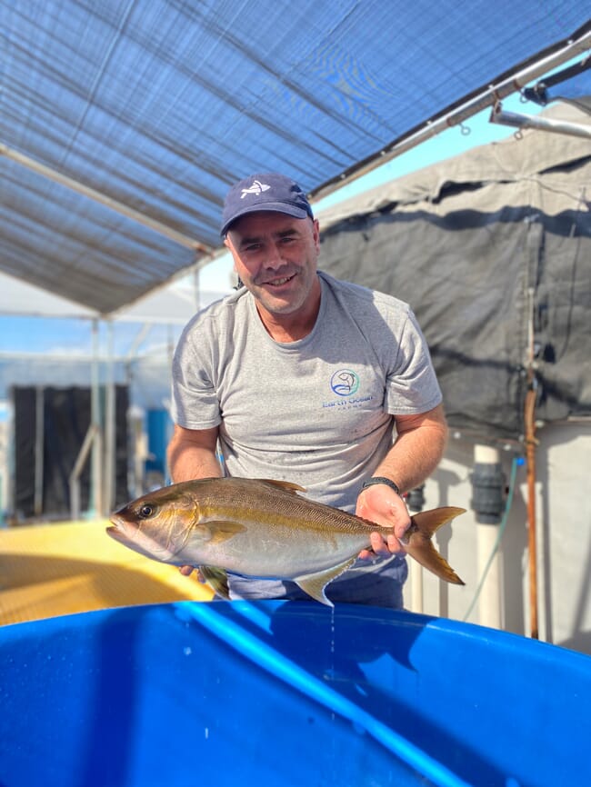 a man holding a live fish