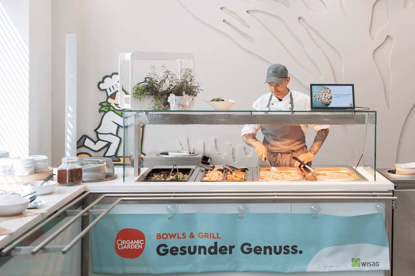 a man serving food in a canteen