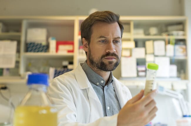 A researcher holding a fish based protein powder