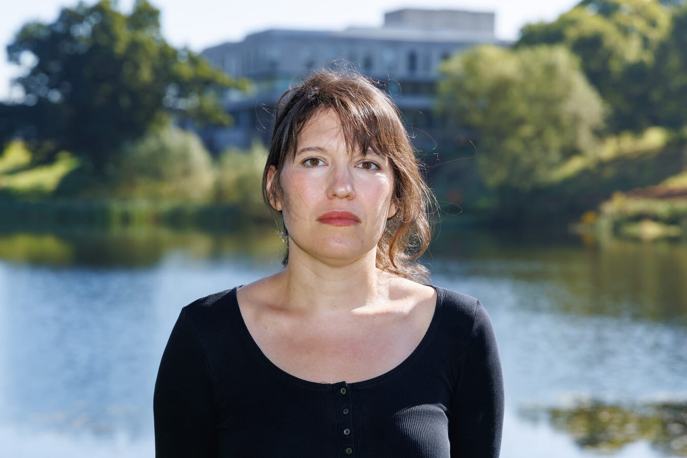 A photo of a researcher infront of Stirling University.