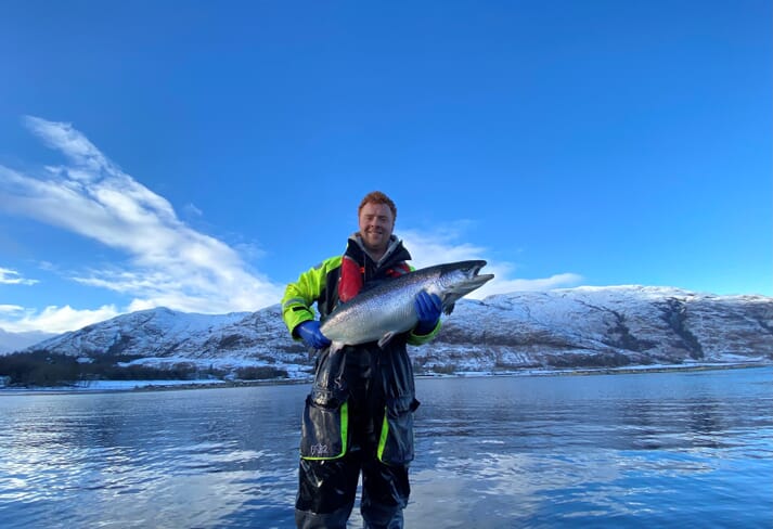 man holding a salmon