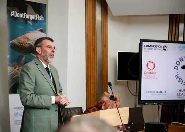 A man speaking from behind a podium.