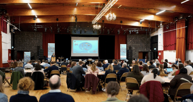 A conference room full of people discussing seaweed aquaculture in the UK.