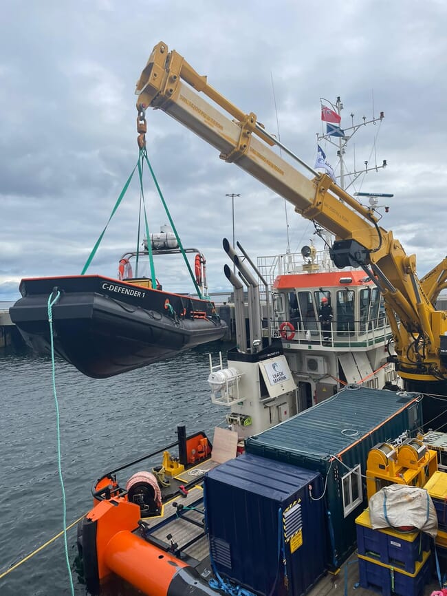 Workboat being lifted on a crane