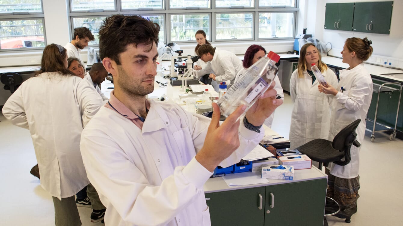 A group of students in a lab learning about seaweed cultivation.