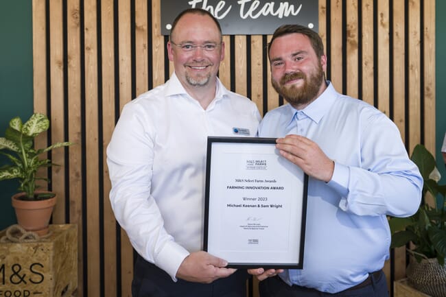 Two men holding an award