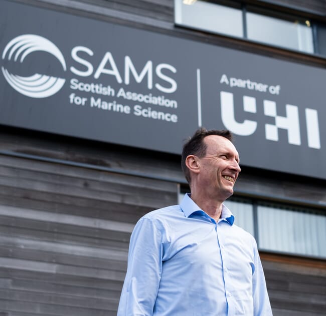 A man standing infront of a building.