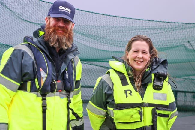 Two people at a fish farm.