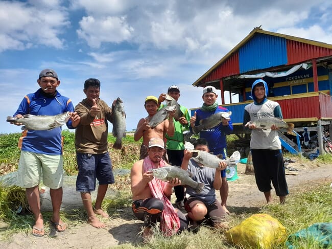 Group of men holding fish