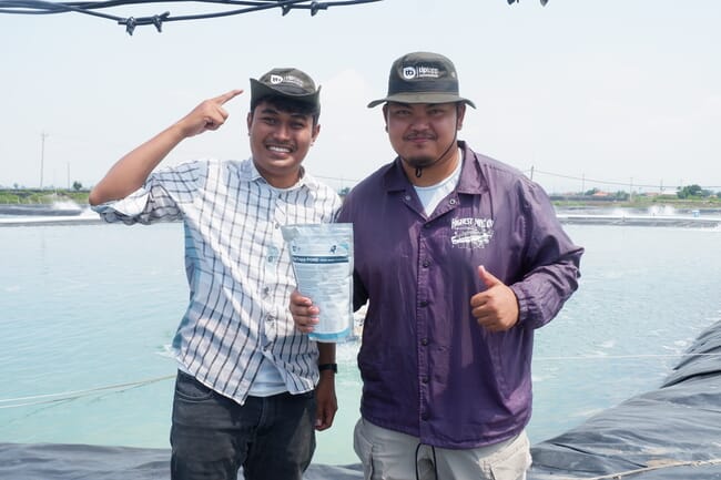 Two men with shrimp probiotics, Tiptopp aquaculture.