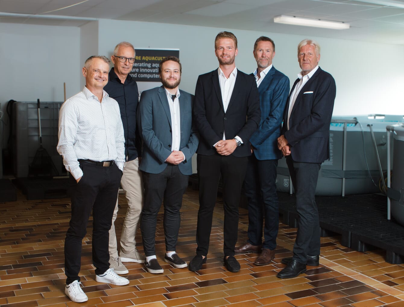 six men posing for a photo