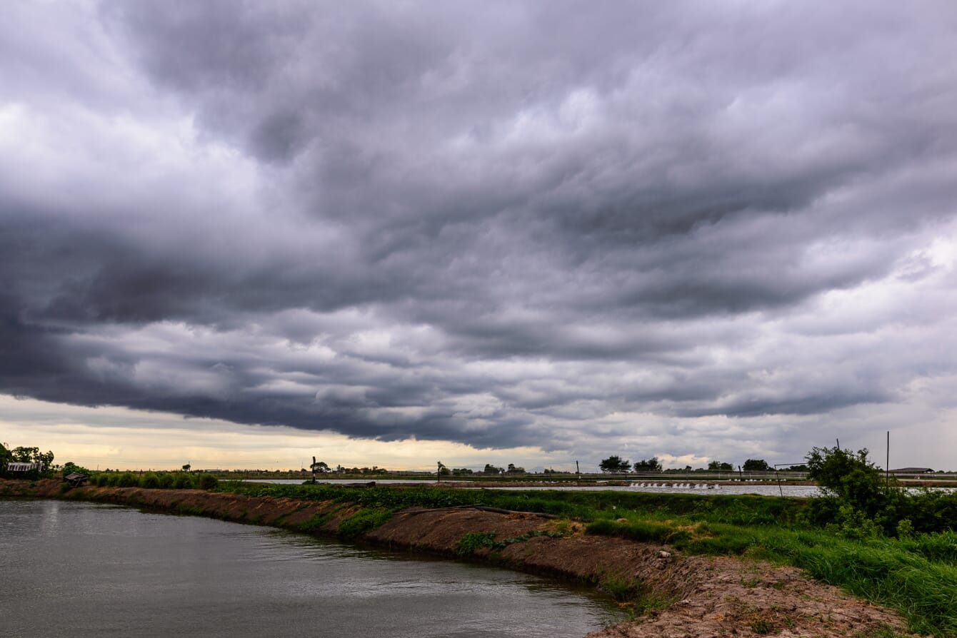 rain clouds gathering above an inland shrimp farm