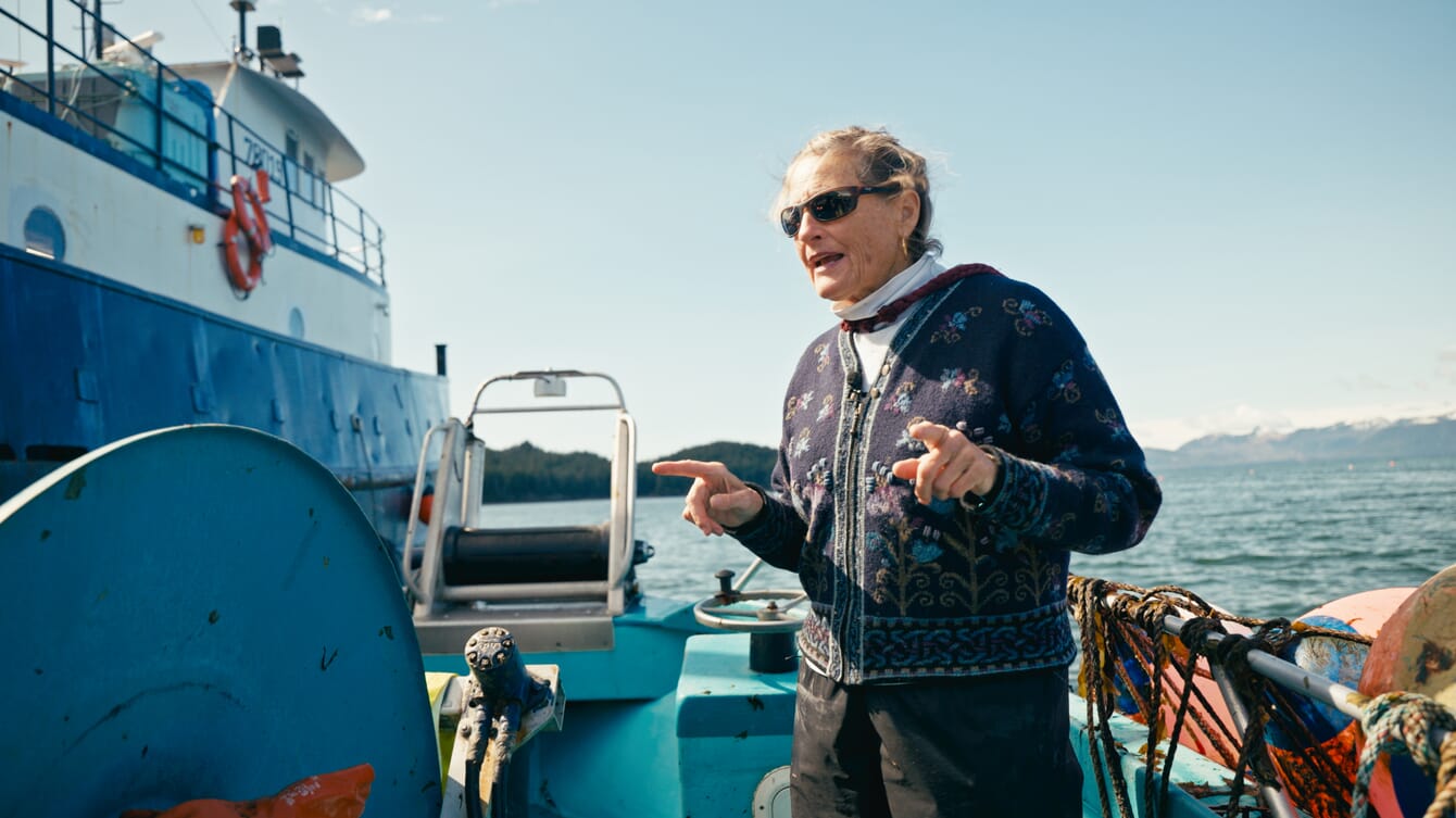 A woman standing on a boat.
